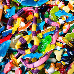 Assorted colorful gummy candy mix with worms, sharks, and animal shapes