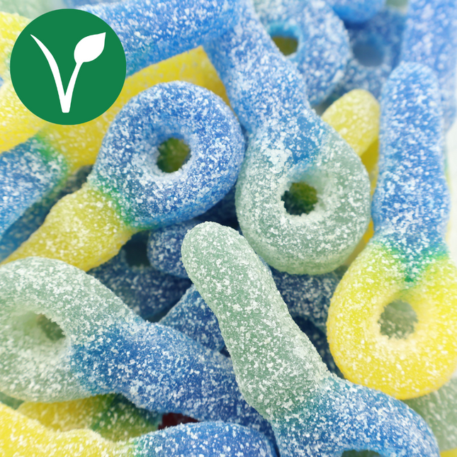 Vegan fruity gummy candies coated in sugar, blue, green and yellow colors, close-up