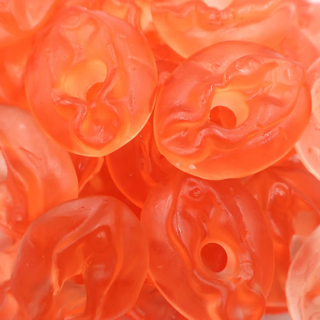 Close-up of pink gummy candies with a soft, translucent texture and round shape