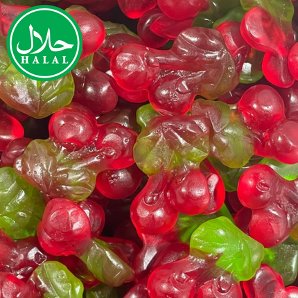 Halal cherry-shaped gummy candy with green leaves, red fruit, closeup view